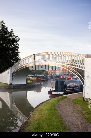 Narrowboats und Bügeleisen Fußgängerbrücke in Braunston Marina auf dem Grand Union Canal. Braunston, Northamptonshire, England Stockfoto