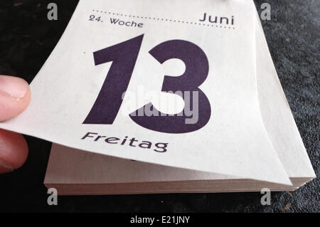 Berlin, Deutschland. 13. Juni 2014. Eine Seite mit einem Kalender das liest "Freitag 13." liegt auf einem Tisch in Berlin, Deutschland, 13. Juni 2014. Freitag, der 13. ist ein unglücklicher Tag von vielen als. Foto: SOEREN STACHE/Dpa/Alamy Live News Stockfoto