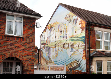 Bedford, UK. 14. Juni 2014. Künstler Iain Carstairs hat gerade sein neueste Werk - ein riesiges Fresko an der Seite seines Hauses vorgestellt.  Das Kunstwerk basierend auf kanadischen Künstlers AJ Casson "weiße Dorf" jetzt ziert die Außenwand seines bescheidenen Ende Reihenhaus in Bedford. Es ist das zweite Fresko der Künstler gemalt hat - die erste war am Ende des Jahres 2012 vor einem Café in der Stadt abgeschlossen. Kredit-14. Juni 2014: KEITH MAYHEW/Alamy Live-Nachrichten Stockfoto