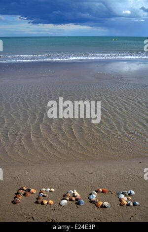 Frieden mit Muscheln am Strand geschrieben. Stockfoto