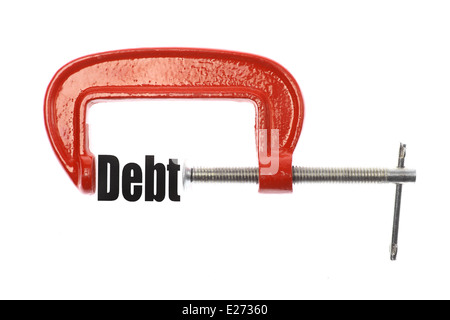 Das Wort "Schulden" ist mit einem Schraubstock komprimiert. Business-Metapher. Stockfoto
