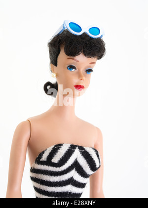 Barbie Fashion-Puppe von Mattel hat zuerst 1959 brünette, Pferdeschwanz, schwarz-weiße Zebra-Badehose, gerades Bein. 1961 Perlenohrringe, Augenbrauen Stockfoto