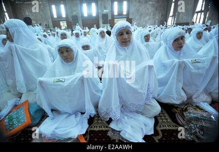 Jakarta, Indonesien. 18. Juni 2014. Indonesische muslimische Frauen tragen Schleier erhalten kostenlos, um der heilige Fastenmonat Ramadan in Sunda Kelapa Moschee in Jakarta, Indonesien, 18. Juni 2014 begrüßen zu dürfen. Bildnachweis: Agung Kuncahya B./Xinhua/Alamy Live-Nachrichten Stockfoto