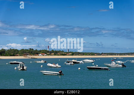 Frankreich, Gironde, d ' Arcachon, Cap Ferret, Plage du Phare, Motorboote verankert abseits am Strand vor einem Leuchtturm Stockfoto