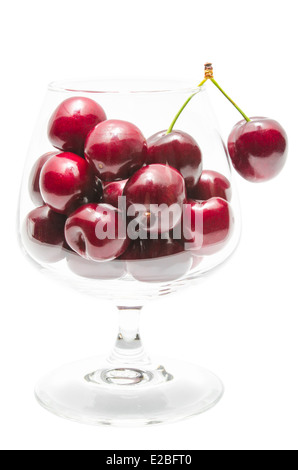 Reife Kirsche große Beeren in transparent klar Weinglas isoliert auf weiss Stockfoto