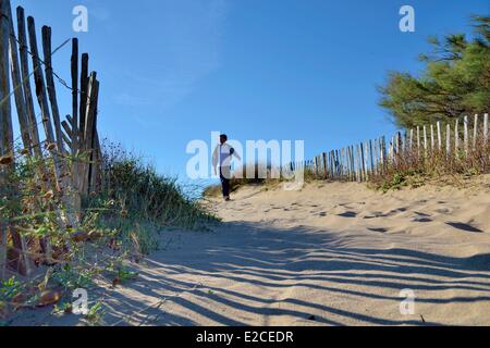 Frankreich, Herault, Serignan, Domaine des Orpellieres, Mann zu Fuß auf einem Weg der Sand zum Strand führt Stockfoto