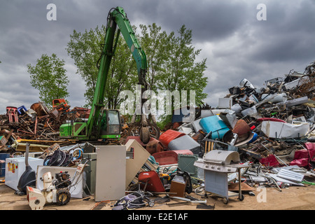 eine grüne hydraulische Ausrüstung arbeiten auf einem Schrottplatz Stockfoto