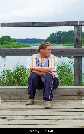 Lebensstil der ländlichen Sommer 2013. Die Einwohner des Dorfes hat einen Rest - sitzt auf dem Bürgersteig der Holzbrücke. Stockfoto