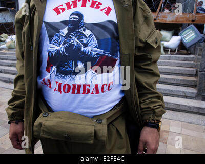 Luhansk, Ukraine. 19. Juni 2014. Ein Mann in eine Tarnung und T-shirt mit Aufschrift "Battle of Donbass" inmitten von Luhansk Regionalverwaltung--Separatist militante in der Ostukraine haben den Vorschlag des Präsidenten zu ergeben, ignoriert, wie in Bezug auf die Friedensregelung vorgeschrieben. Dies zeigt sich eine Zunahme der Zahl von militärischer Ausrüstung, Terroristen und bewaffnete Angriffe auf Soldaten der ukrainischen Armee. Bildnachweis: Igor Golovnov/Alamy Live-Nachrichten Stockfoto