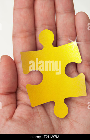 Gold Puzzleteil Stockfoto