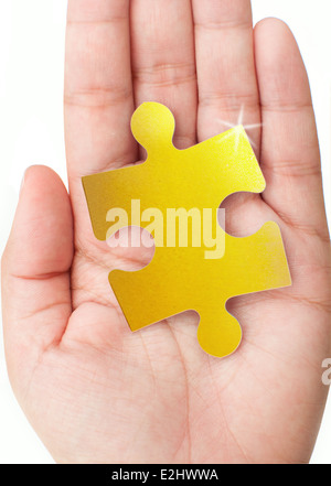 Gold Puzzleteil Stockfoto