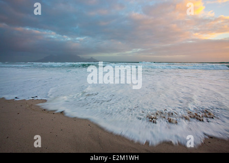 Blick vom Strand am Bloubergstrand über den Ozean mit einem klassischen Blick auf den Tafelberg über die Bucht. Stockfoto