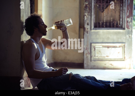 Menschen, Drogenmissbrauch und häuslicher Gewalt. Porträt des jungen Alcoholist betrunken männliche trinken Whisky zu Hause Stockfoto