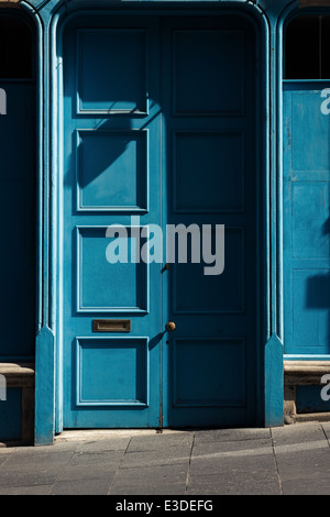 Hell erleuchteten blaue Türen in einer Seitenstraße Old Town Edinburghs Royal Mile Stockfoto