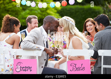 Braut und Bräutigam genießen Mahlzeit bei Hochzeitsfeier Stockfoto