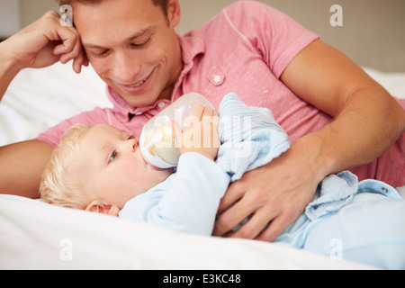 Vater Sohn Babyflasche Milch geben Stockfoto