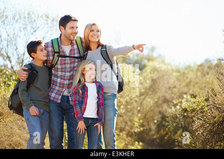 Familie Wandern im Land tragen Rucksäcke Stockfoto