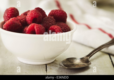 Himbeeren in Schüssel auf weißem Hintergrund Stockfoto