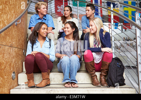 Gruppe von High School Studenten sitzen außen Gebäude Stockfoto