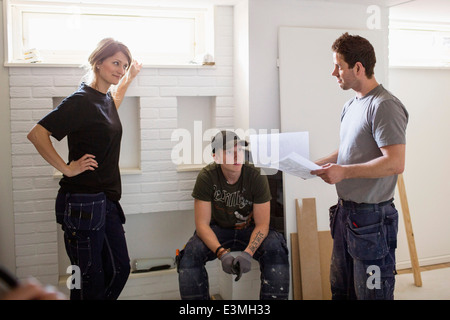 Tischler diskutieren über Dokumente am Standort Stockfoto