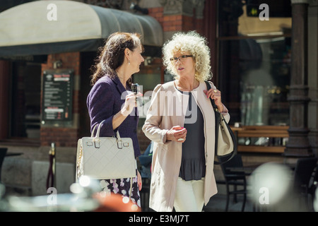 Frauen in Führungspositionen im Gespräch während des Gehens auf Stadtstraße Stockfoto