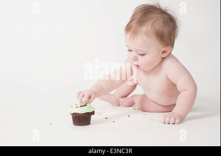 Volle Länge des jungen essen Kuchen vor weißem Hintergrund Stockfoto