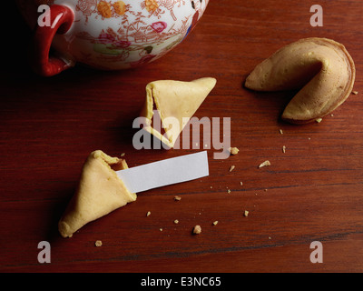 Blankopapier im gebrochenen Glückskeks auf Holztisch Stockfoto