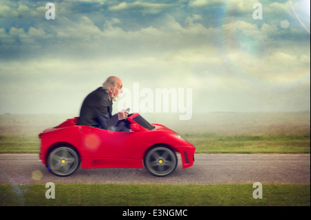 Senior woman genießen einen Spielzeug-Rennwagen fahren Stockfoto