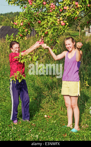 Lebensstil der ländlichen Sommer 2013. Bewohner des Dorfes - Mutter und Tochter in der Nähe von einem Apfelbaum. Stockfoto