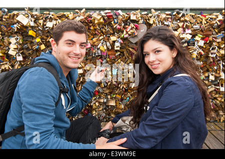 frisch Verliebte, die Verriegelung ein Vorhängeschloss auf der Pont des Arts Paris zu überbrücken Stockfoto