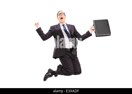 Geschäftsmann mit Aktenkoffer springen vor Freude Stockfoto