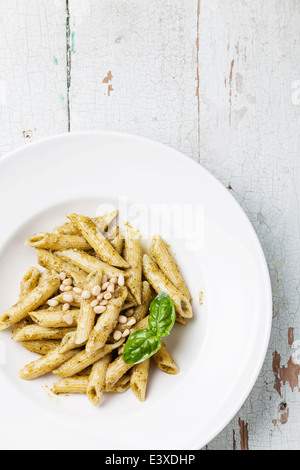 Pasta Penne mit Pesto und Pinienkernen auf hölzernen Hintergrund Stockfoto