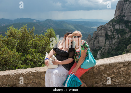 Porträt von Mutter und Tochter, die auf der Brüstung in Montserrat Abbey, Spanien sitzen. Stockfoto