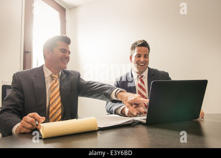 Zwei männliche Wirtschaftsanwälte im Chat im Büro Stockfoto