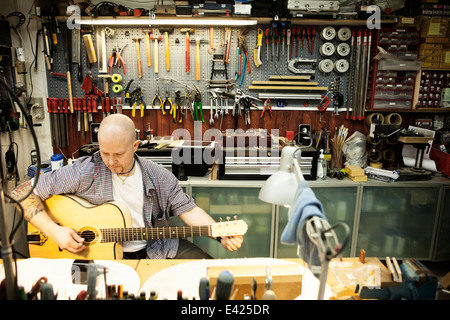 Gitarrenbauer tuning Akustikgitarre in Werkstatt Stockfoto