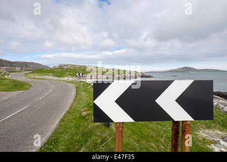 Schwarze und weiße Chevron Zeichen Warnung scharfe Lefthand auf einer Küstenstraße auf South Uist Äußere Hebriden Western Isles Schottland Großbritannien beugen Stockfoto