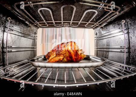 Gebratenes Huhn in den Ofen, Blick aus dem Inneren des Ofens. Kochen in den Ofen. Stockfoto