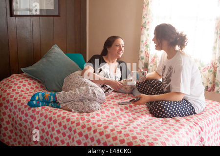 Mutter und Tochter Spielkarten auf Bett Stockfoto