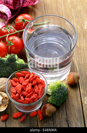 getrocknete Goji-Beeren, Wasser, Nüssen und frischem Gemüse für eine gesunde Ernährung Stockfoto