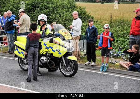 Green Hammerton, Yorkshire, Großbritannien. 6. Juli 2014. Polizist geben junge Zuschauer ein high Five vor Beginn der Tour De France Credit: Richard Burdon/Alamy Live News Stockfoto