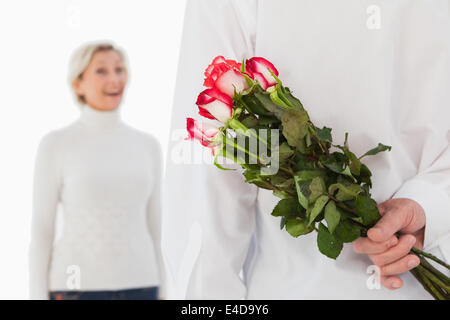 Mann versteckt Strauß Rosen aus älteren Frau Stockfoto