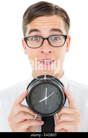 Geeky Geschäftsmann Holding Wecker Stockfoto