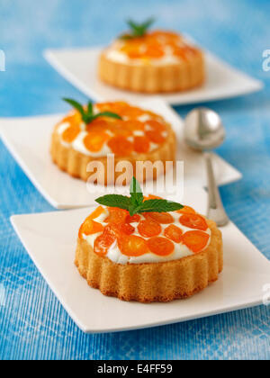 Törtchen mit Käse und Kumquats. Rezept zur Verfügung. Stockfoto