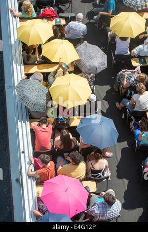 Berlin, Deutschland. 10. Juli 2014. Passagier der Fähre Boot schützen sich vor der Sonne mit Sonnenschirmen in Berlin, Deutschland, 10. Juli 2014. Foto: MAURIZIO GAMBARINI/Dpa/Alamy Live News Stockfoto