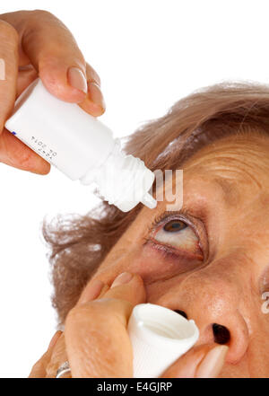 Ältere Frau Augentropfen Anwendung auf weißem Hintergrund Stockfoto