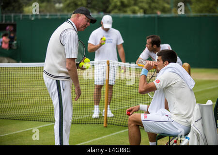 Boris Becker links () Trainer Novak Djokovic (rechts), wie er auf Court Nr. 4 The Championships Wimbledon 2014 die alle Engla praktiziert Stockfoto