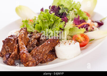 gegrilltes Rindfleisch Streifen frischen gemischten Salat und warmen Ziegenkäse Stockfoto