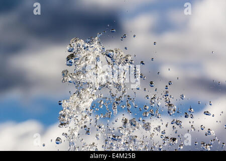 Brunnen fällt der brillante Reinwasser gegen Wolken Stockfoto