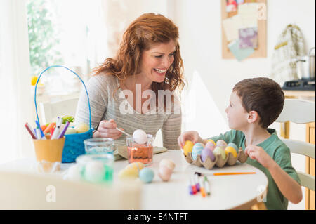 Mutter und Sohn (6-7) bemalen von Ostereiern Stockfoto