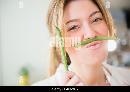 Porträt der blonden Frau mit grünen Bohnen Stockfoto